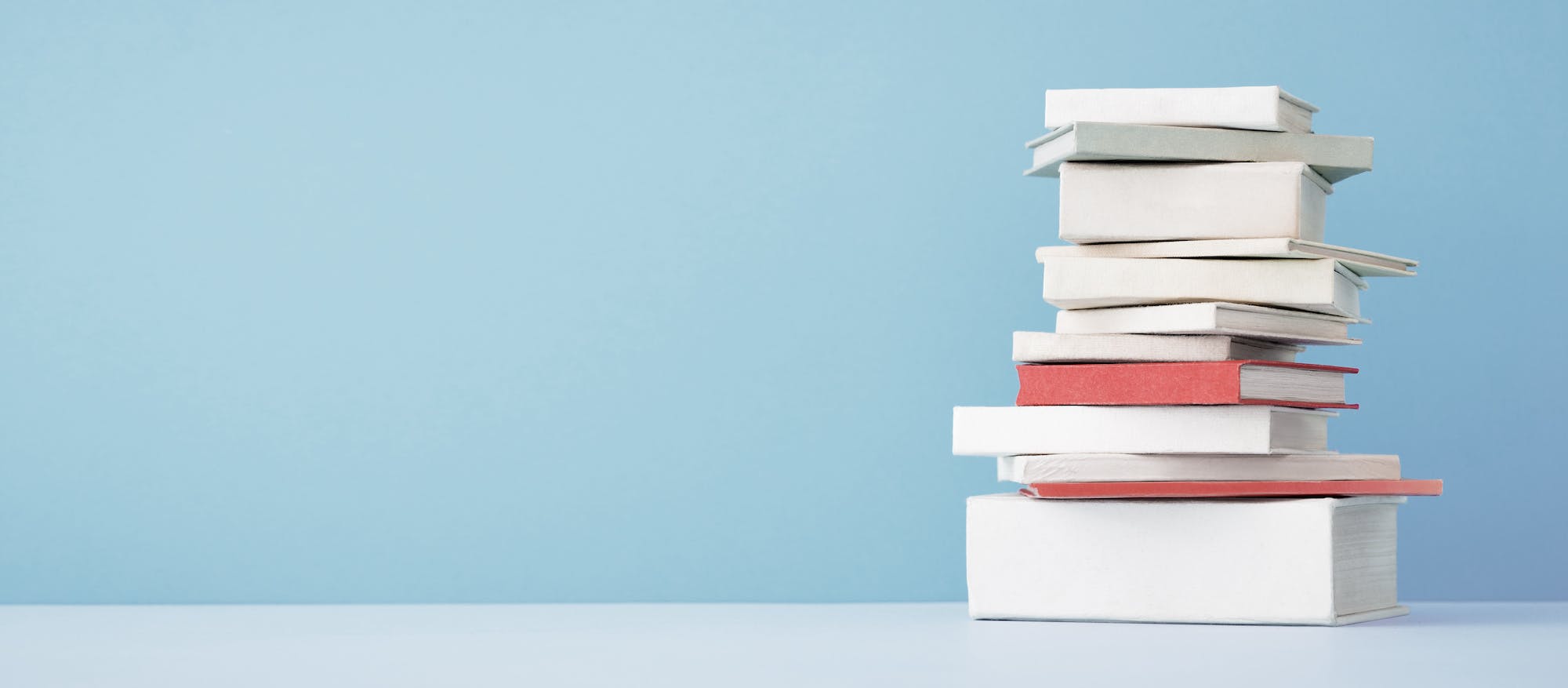 stack of books on blue background